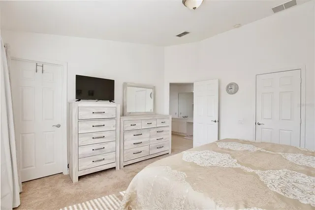 a bedroom with a bed and a television