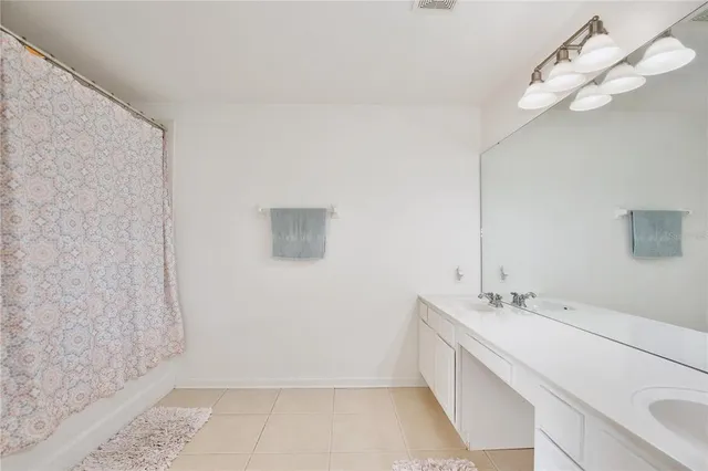 a bathroom with a double vanity sink and a mirror