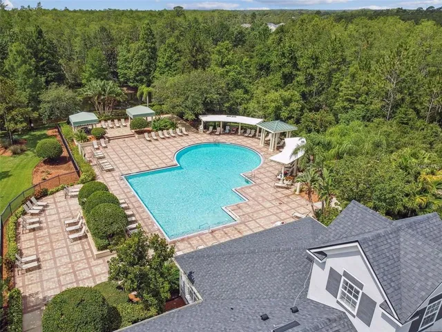 an aerial view of a house with yard swimming pool and outdoor seating