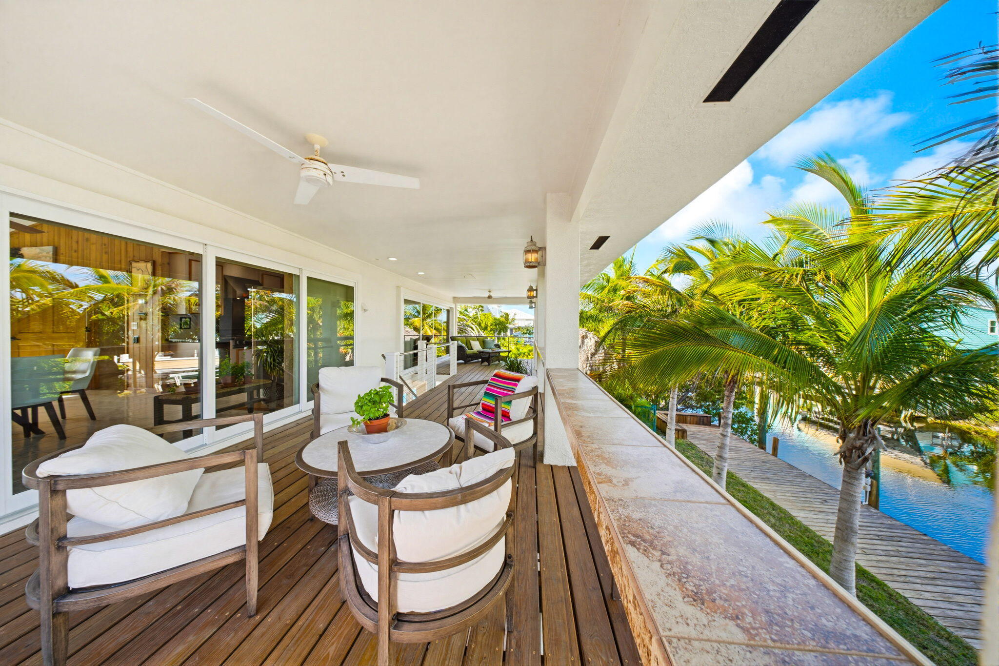 403 Indies Road Summerland Key, FL 33042 - Photo 11 of 68 a dining room with furniture a potted plant and wooden floor