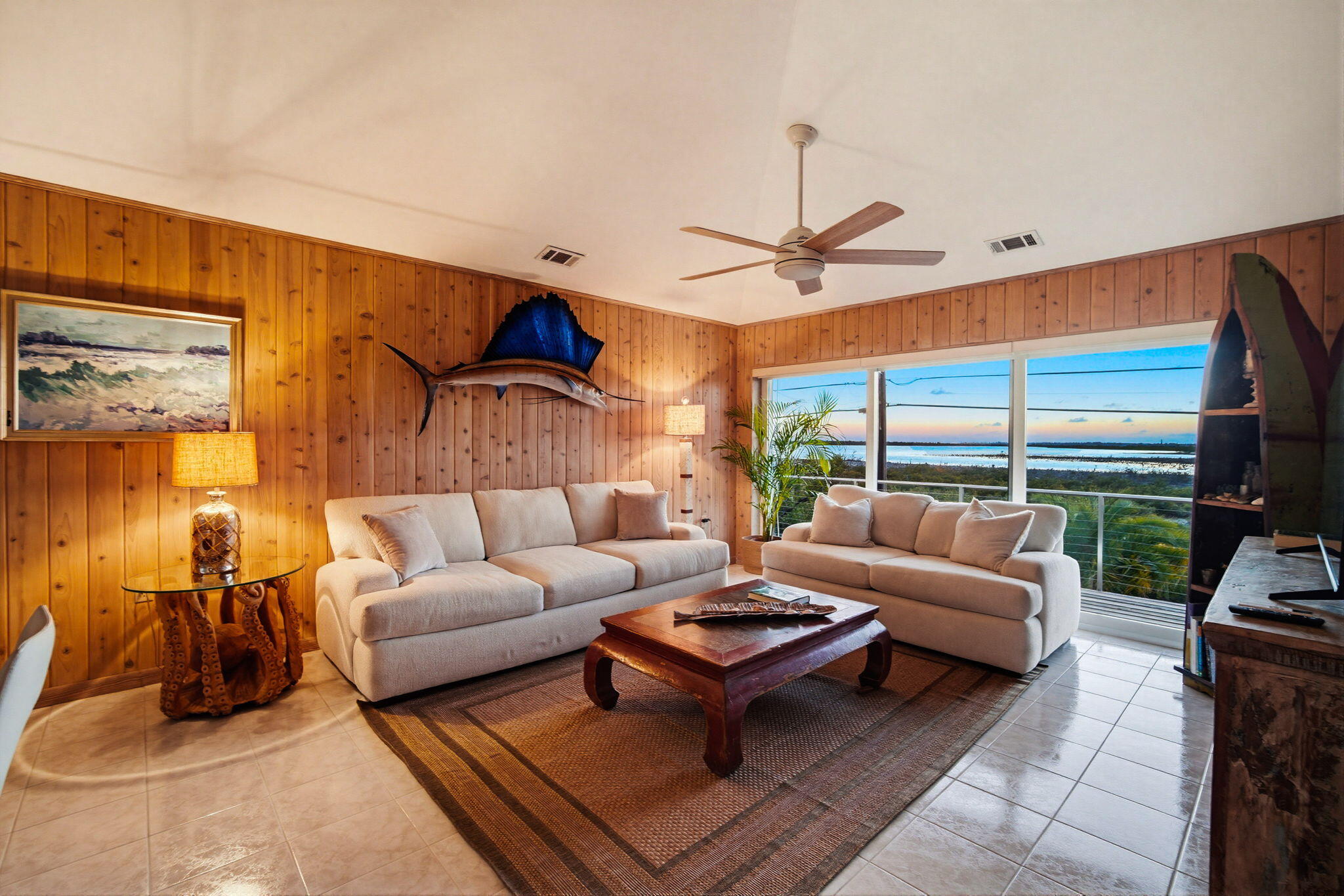 403 Indies Road Summerland Key, FL 33042 - Photo 15 of 68 a living room with furniture a ceiling fan and a large window
