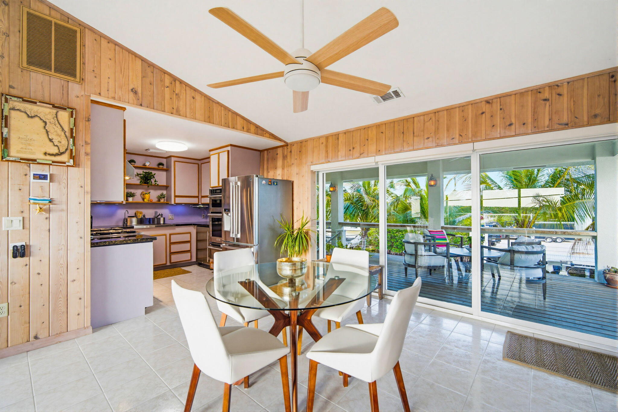403 Indies Road Summerland Key, FL 33042 - Photo 16 of 68 a dining room with furniture water view and a floor to ceiling window