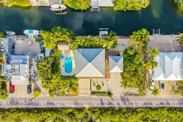 a dining room with furniture a potted plant and wooden floor