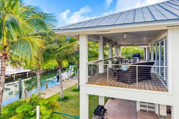 a dining room with furniture water view and a floor to ceiling window