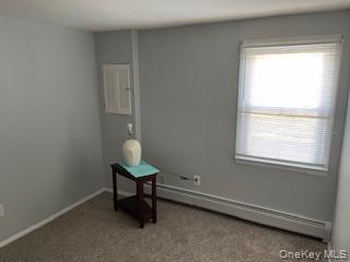 146-148 Ridge Street Pearl River, NY 10965 - Photo 13 of 19 LL The room features light gray walls, a window with horizontal blinds, and carpeting