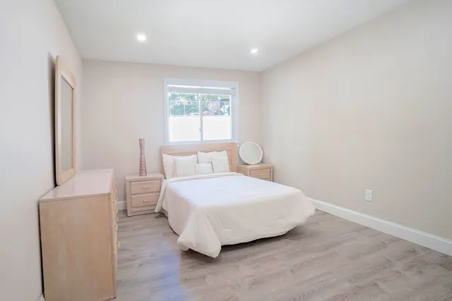 a large white bed in a white room