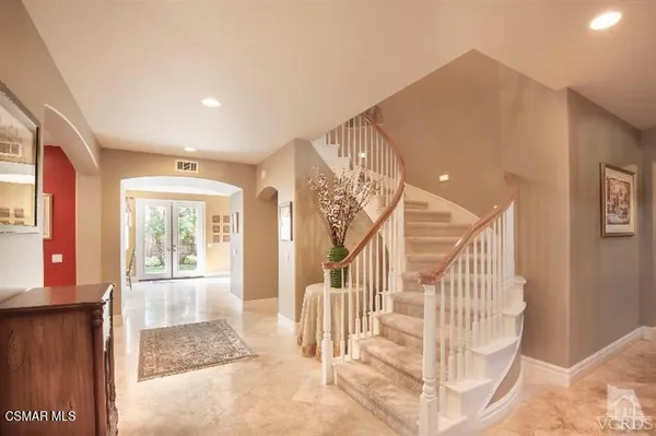 a view of entryway and hall with wooden floor