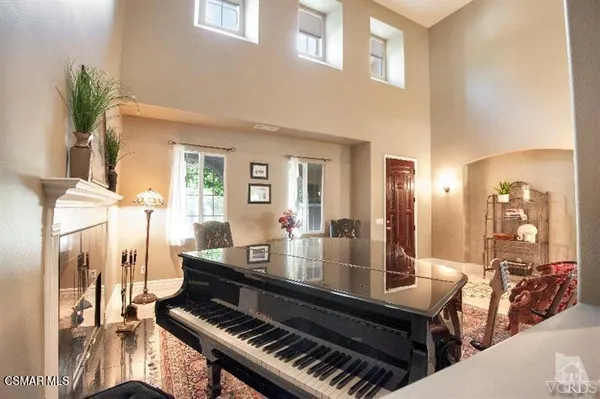 a living room with furniture and a piano