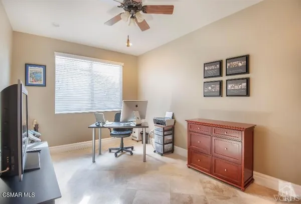 a work room with furniture and a window