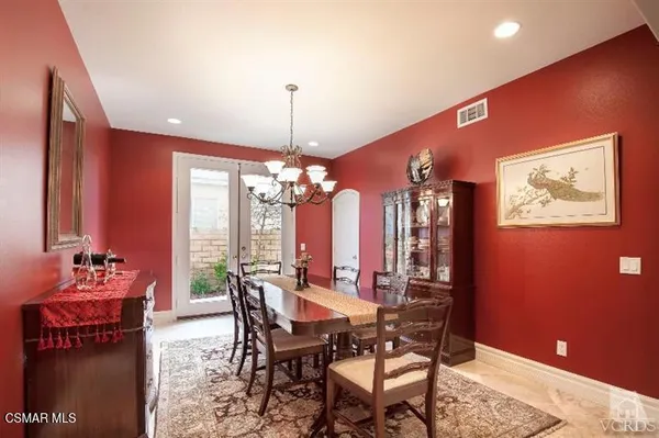 a view of a dining room with furniture and chandelier
