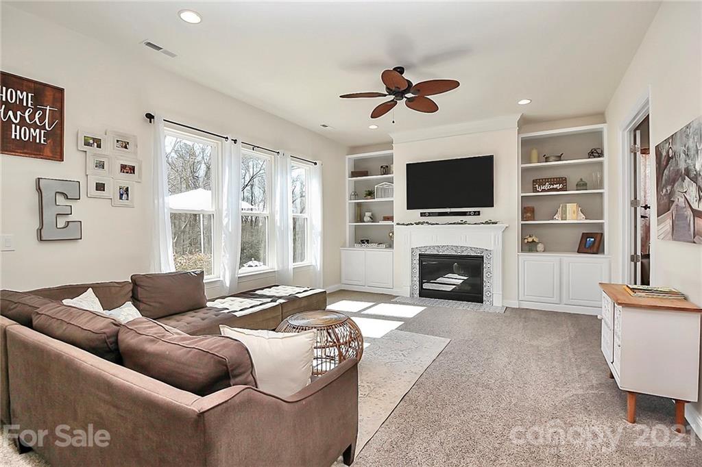 86523 Arrington Road Lancaster, SC 29720 - Photo 14 of 43 a living room with furniture a fireplace and a flat screen tv