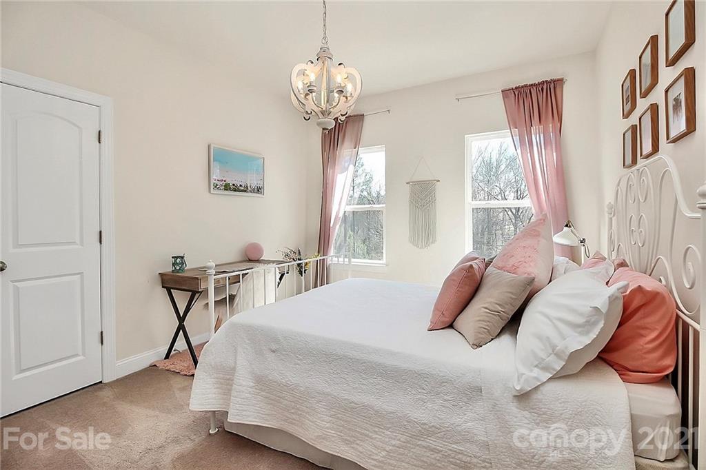 86523 Arrington Road Lancaster, SC 29720 - Photo 24 of 43 a bedroom with bed and a chandelier