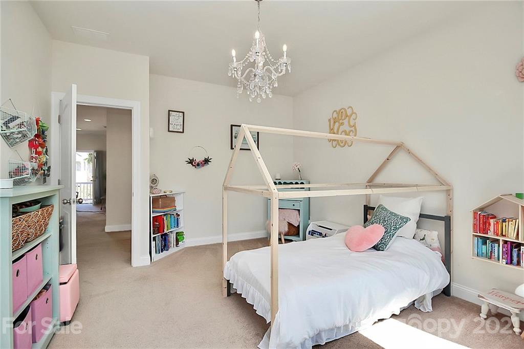 86523 Arrington Road Lancaster, SC 29720 - Photo 26 of 43 a bedroom with a bed and a chandelier