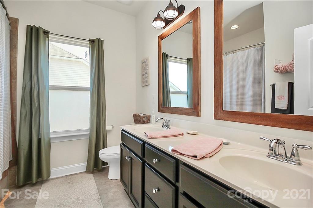 86523 Arrington Road Lancaster, SC 29720 - Photo 27 of 43 a bathroom with a sink double vanity and a mirror