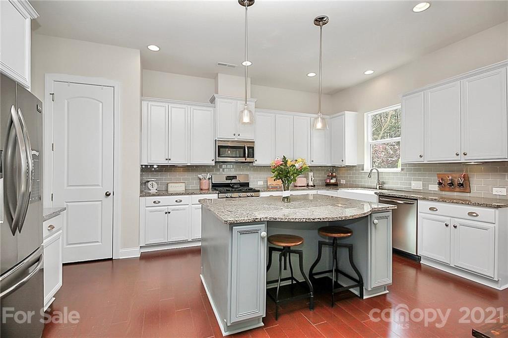 86523 Arrington Road Lancaster, SC 29720 - Photo 8 of 43 a kitchen with stainless steel appliances kitchen island a white cabinets and wooden floor