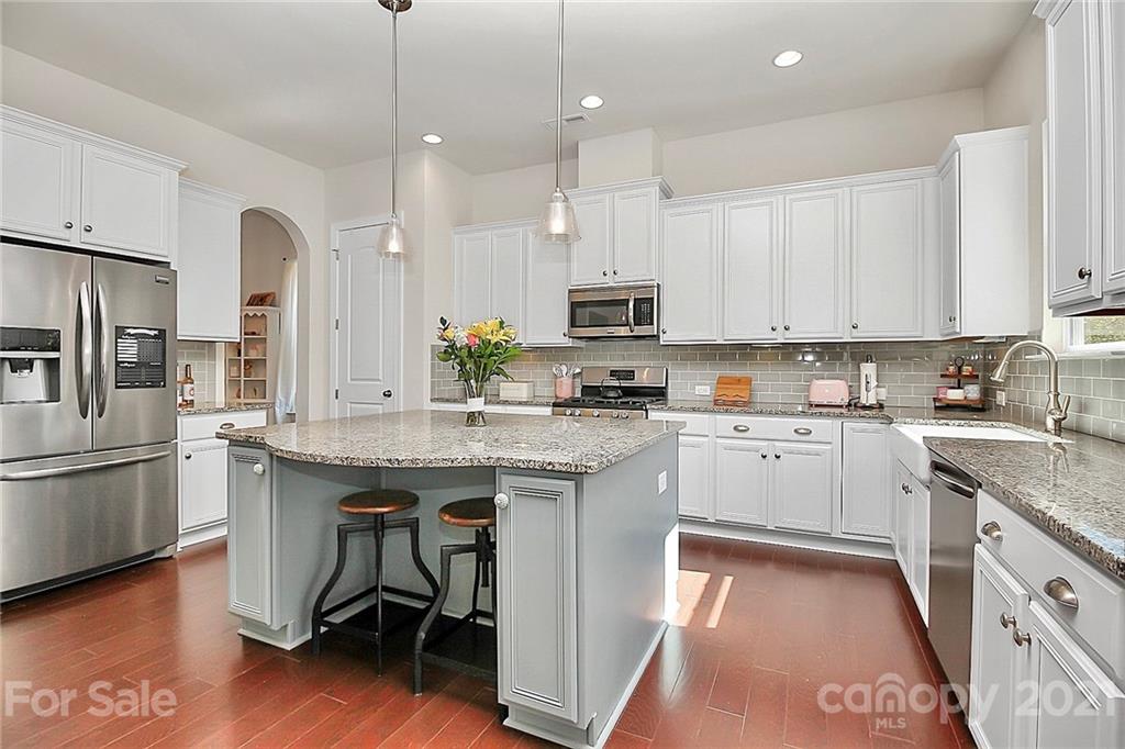 86523 Arrington Road Lancaster, SC 29720 - Photo 9 of 43 a kitchen with kitchen island granite countertop a sink a counter top space stainless steel appliances and cabinets
