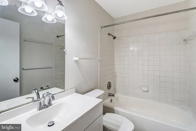 a bathroom with a sink toilet tub and shower