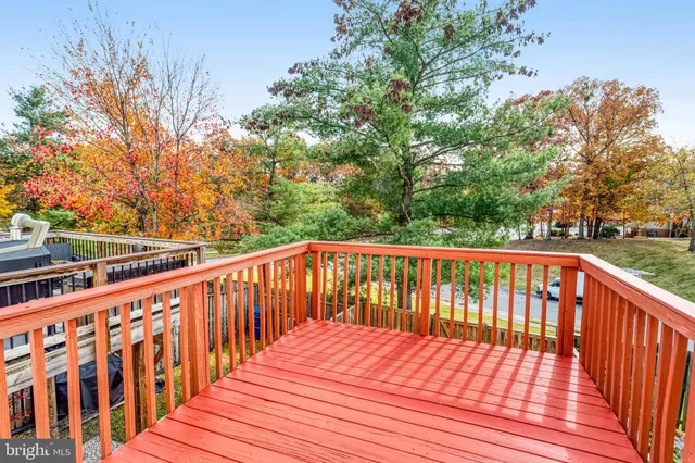 a balcony with wooden floor and fence