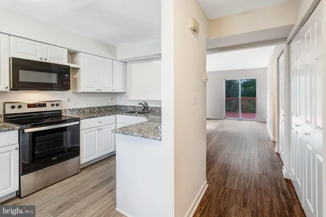 a kitchen with a sink stove and microwave
