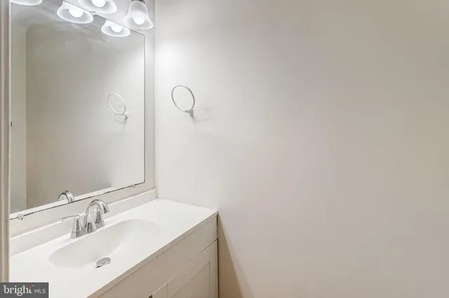 a bathroom with a sink vanity and a mirror