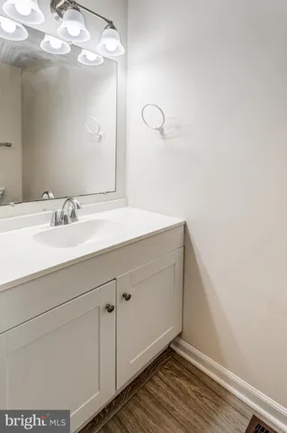 a bathroom with a sink vanity and mirror