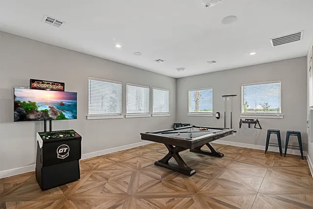 a living room with furniture a window and a flat screen tv
