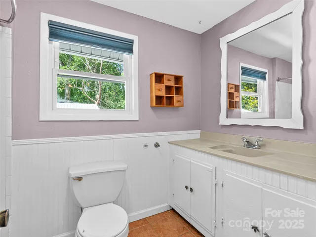 a view of empty room with wooden floor and windows