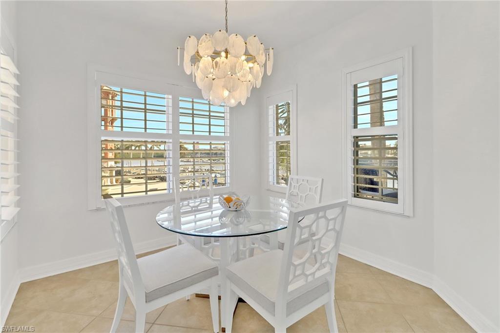 450 Bayfront Place, Unit 4206 Naples, FL 34102 - Photo 11 of 27 a dining room with wooden floor and chandelier