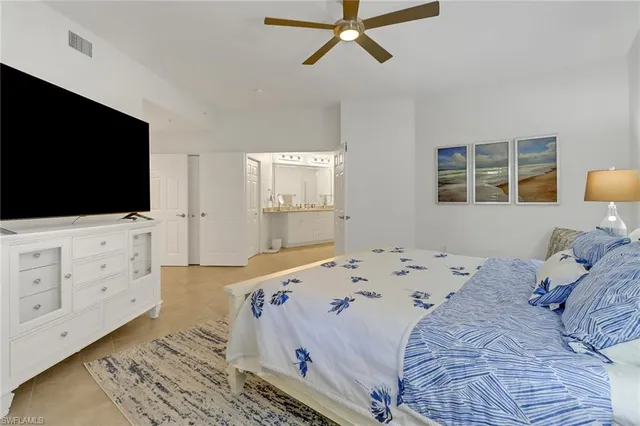 a bedroom with a bed and flat screen tv