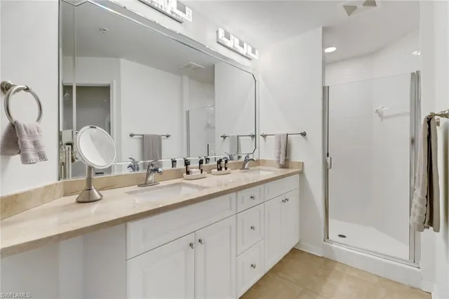 a bathroom with double sink and a mirror
