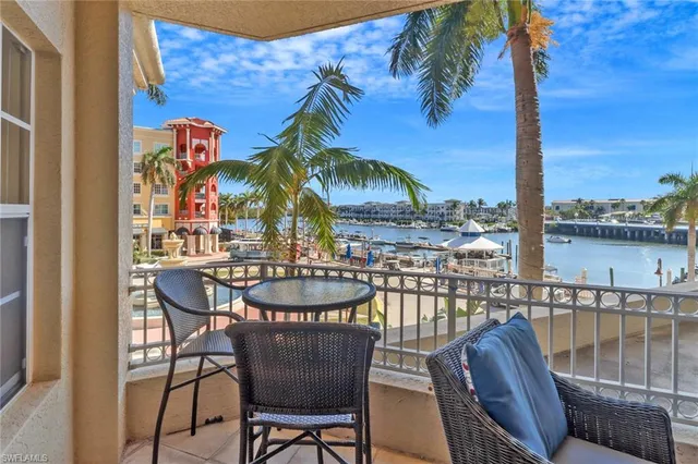 a view of a chairs and table in the balcony