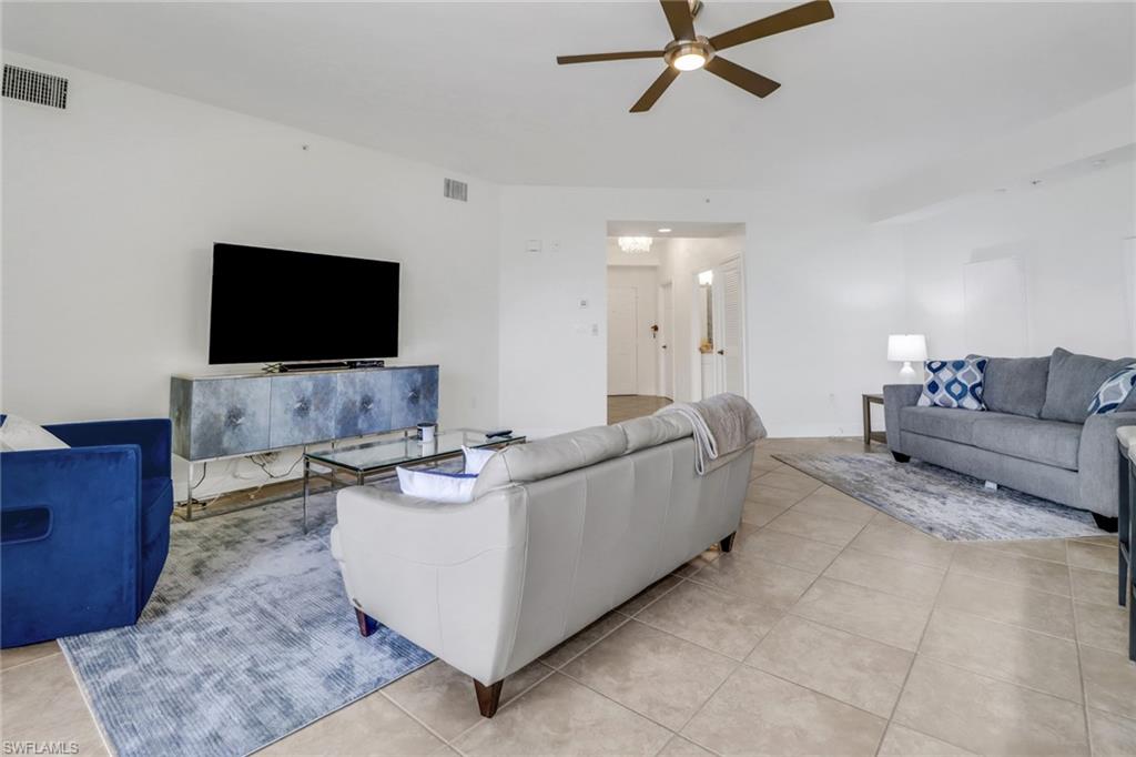 450 Bayfront Place, Unit 4206 Naples, FL 34102 - Photo 4 of 27 a living room with furniture and a flat screen tv
