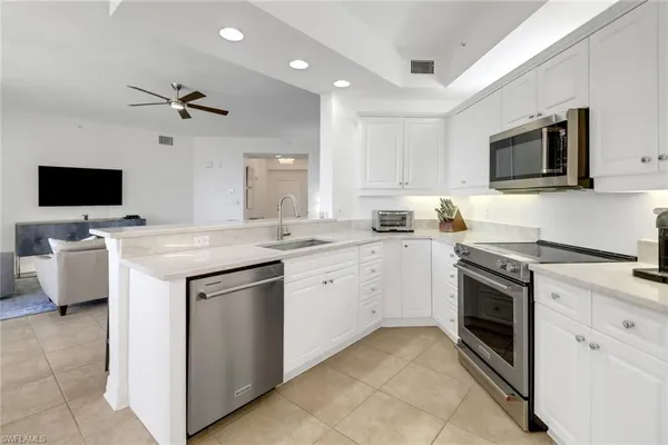 a kitchen with a sink stove and microwave
