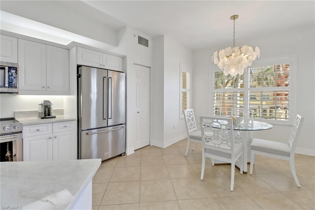 450 Bayfront Place, Unit 4206 Naples, FL 34102 - Photo 10 of 27 a kitchen with stainless steel appliances granite countertop a refrigerator and a wooden cabinets