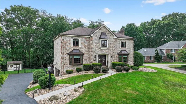 a front view of house with yard and green space
