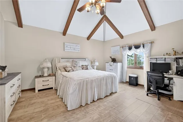 a bedroom with a bed and a chandelier