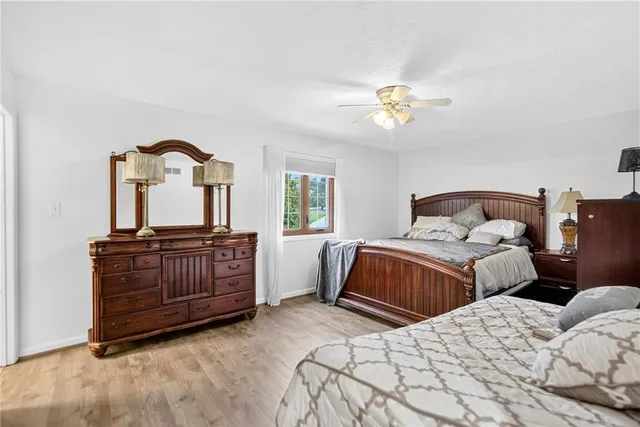 a bedroom with two beds and two mirrors