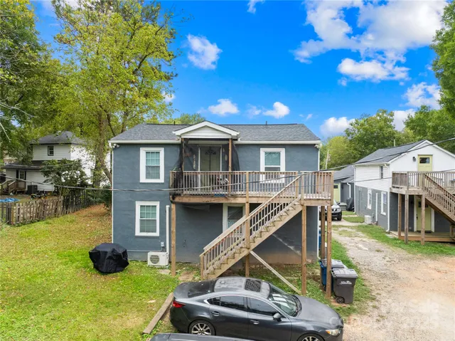a view of a house with a backyard porch and sitting area