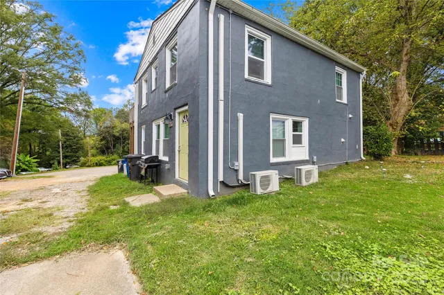 a view of a house with a yard and sitting area