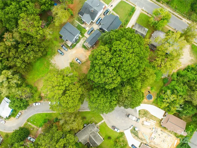an aerial view of a house with yard swimming pool and outdoor seating