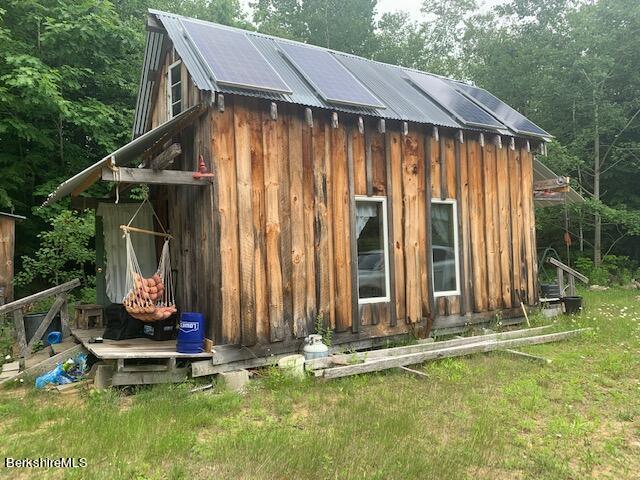 633 Quarry Road Becket, MA 01223 - Photo 6 of 10 a backyard of a house with table and chairs