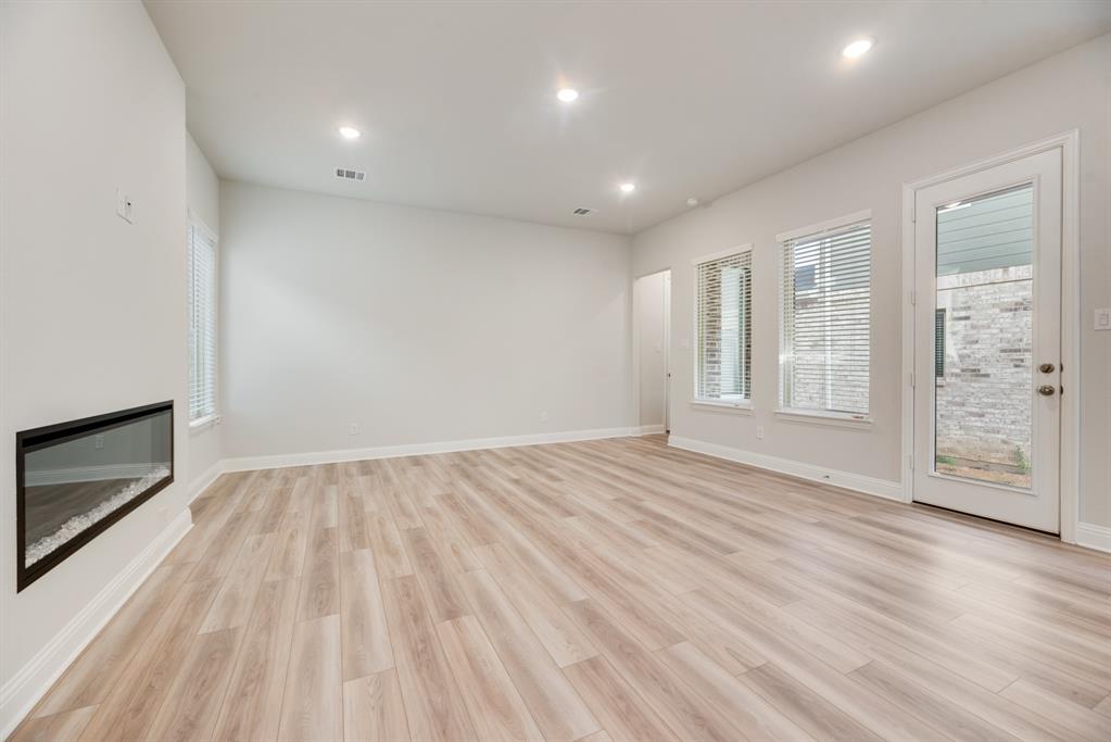 7009 Sunset Boulevard Rowlett, TX 75088 - Photo 15 of 35 a view of an empty room with a fireplace and a window