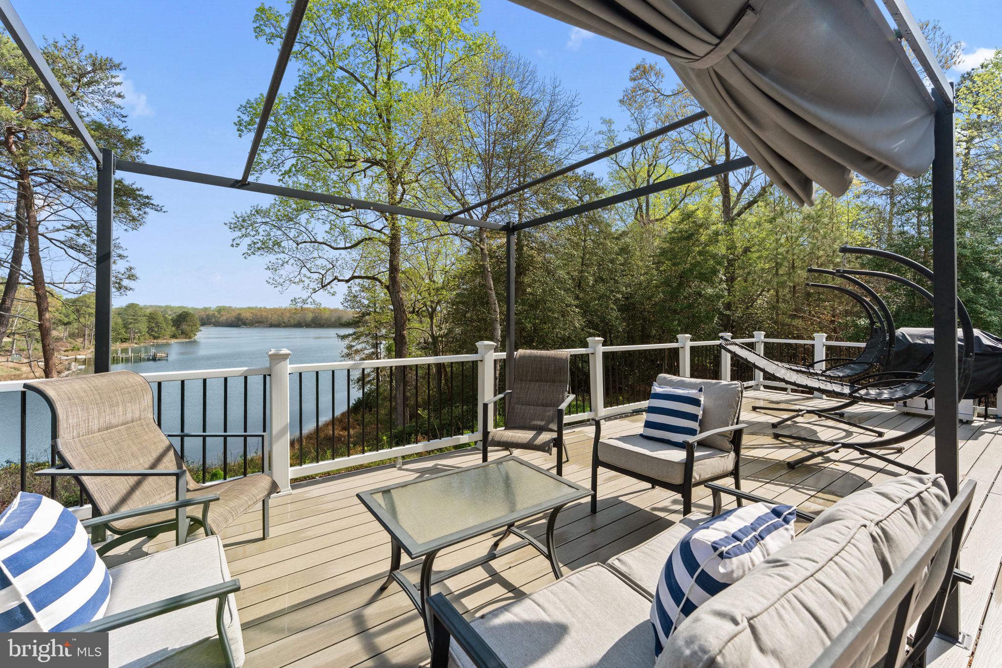 249 Spring Hill Road Lancaster, VA 22503 - Photo 29 of 65 a view of a chairs and table in the balcony