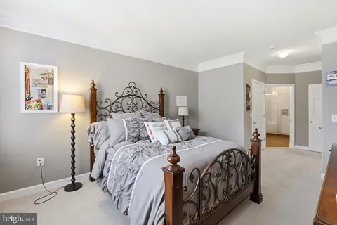 a bedroom with a bed and a painting
