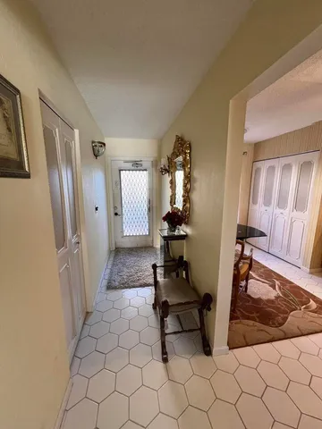 a bathroom with a granite countertop toilet sink and mirror