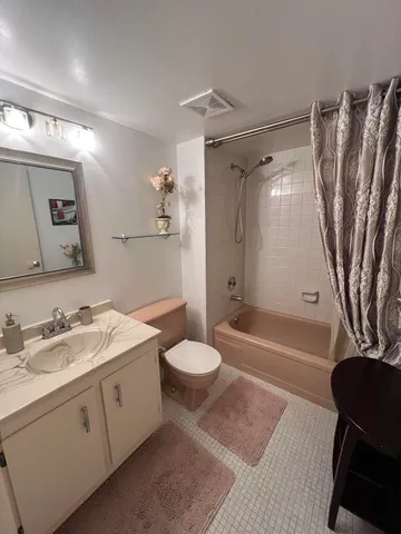 a living room with furniture a rug and a table