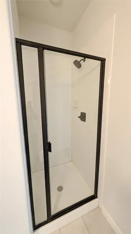 a bathroom with a glass shower door