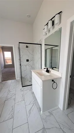 a bathroom with a sink a mirror and shower