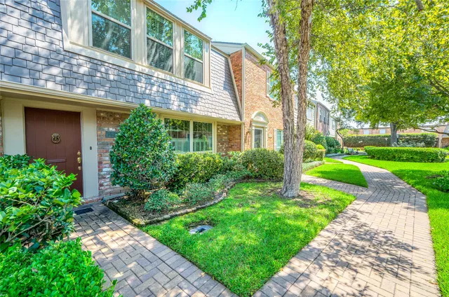 a view of a brick building next to a yard
