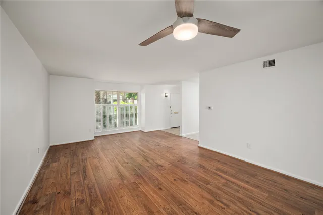 wooden floor in an empty room with a window